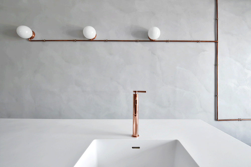 Animated view showing copper lighting installation and white Corian sink designed by Cometa Architects for Marina Apartment in Barcelona