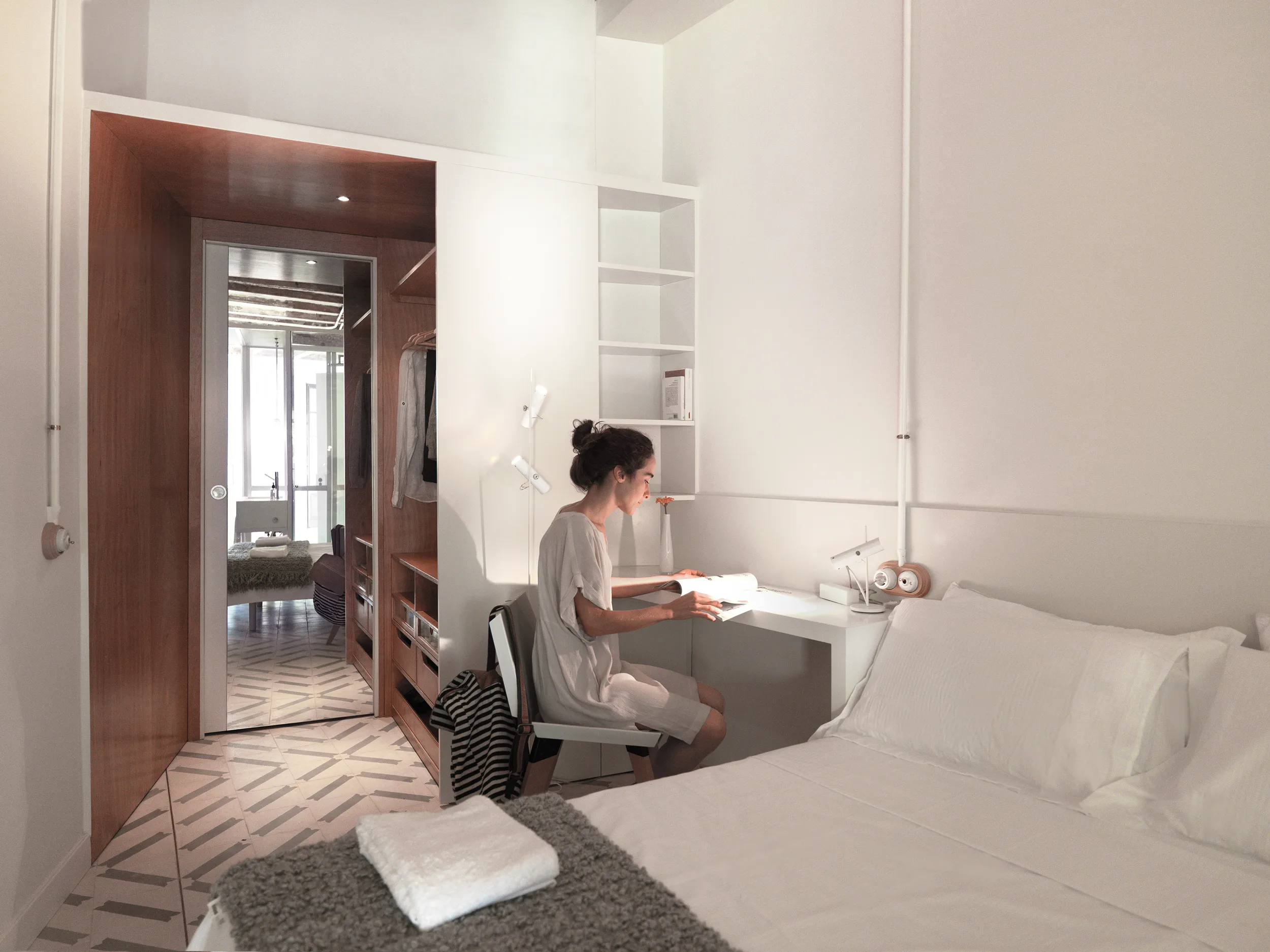 Bedroom with integrated study desk, Okume wood wardrobe, and hydraulic tile flooring in The Lightslice apartment by Cometa Architects