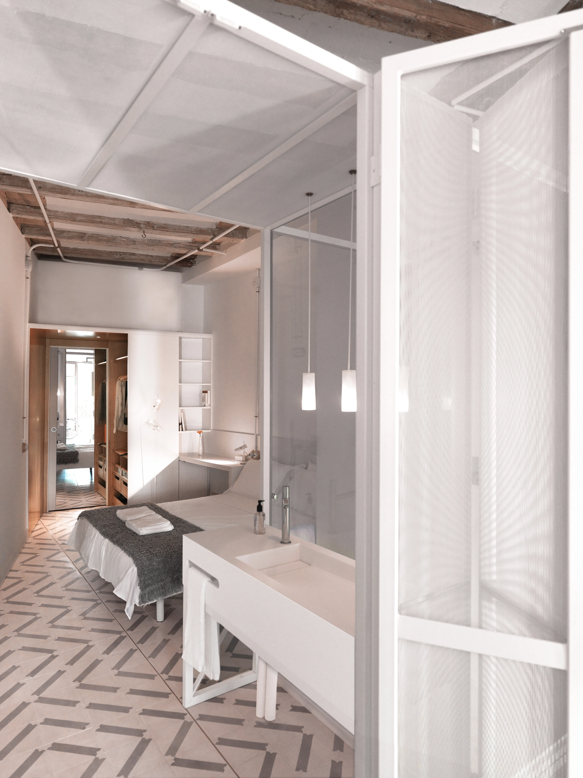 Bedroom and en suite connected along a longitudinal axis with Catalan ceiling and white lattice partition by Cometa Architects