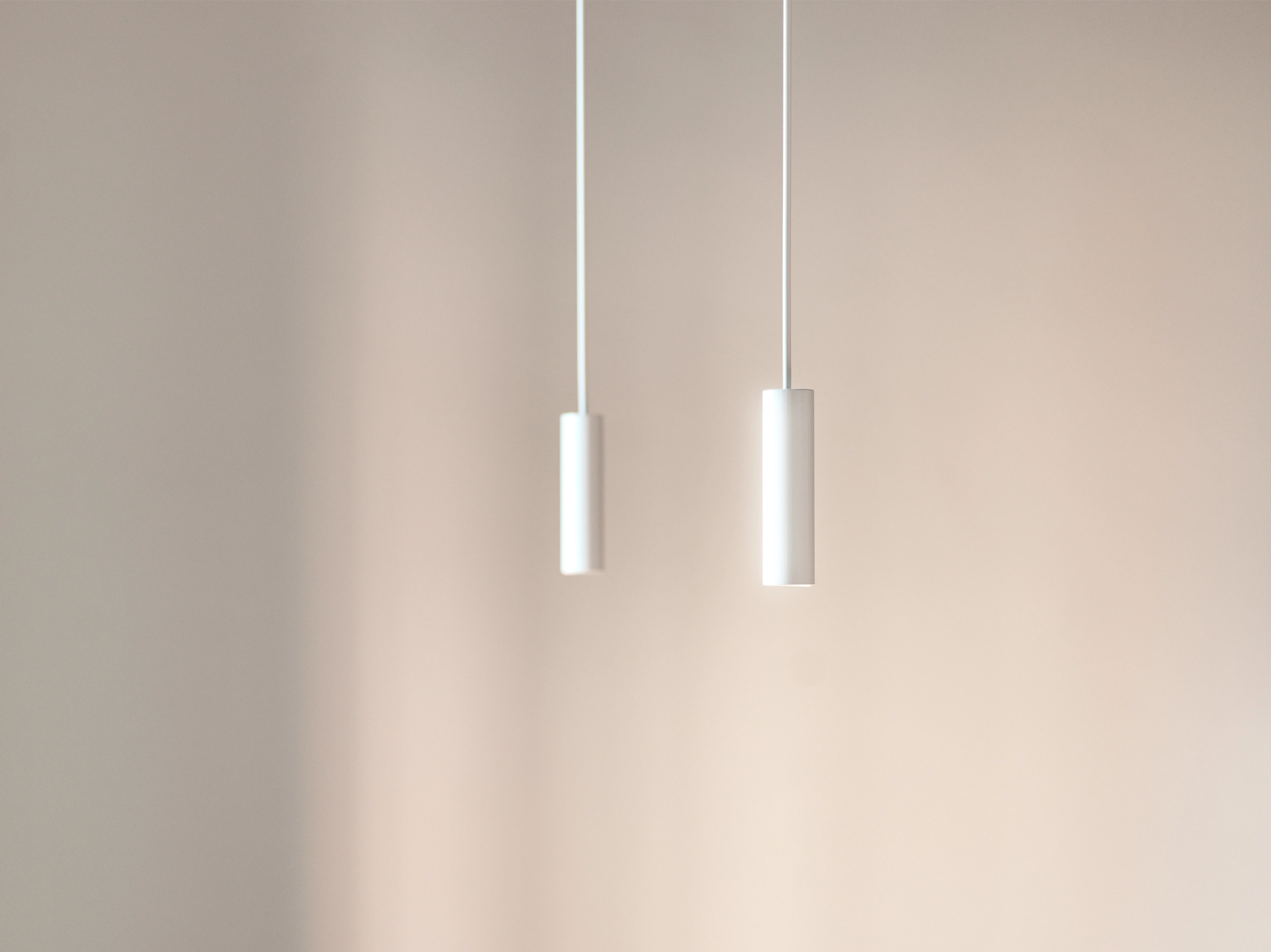 Minimal cylindrical pendant lights designed by Cometa Architects for The Lightslice apartment in Barcelona