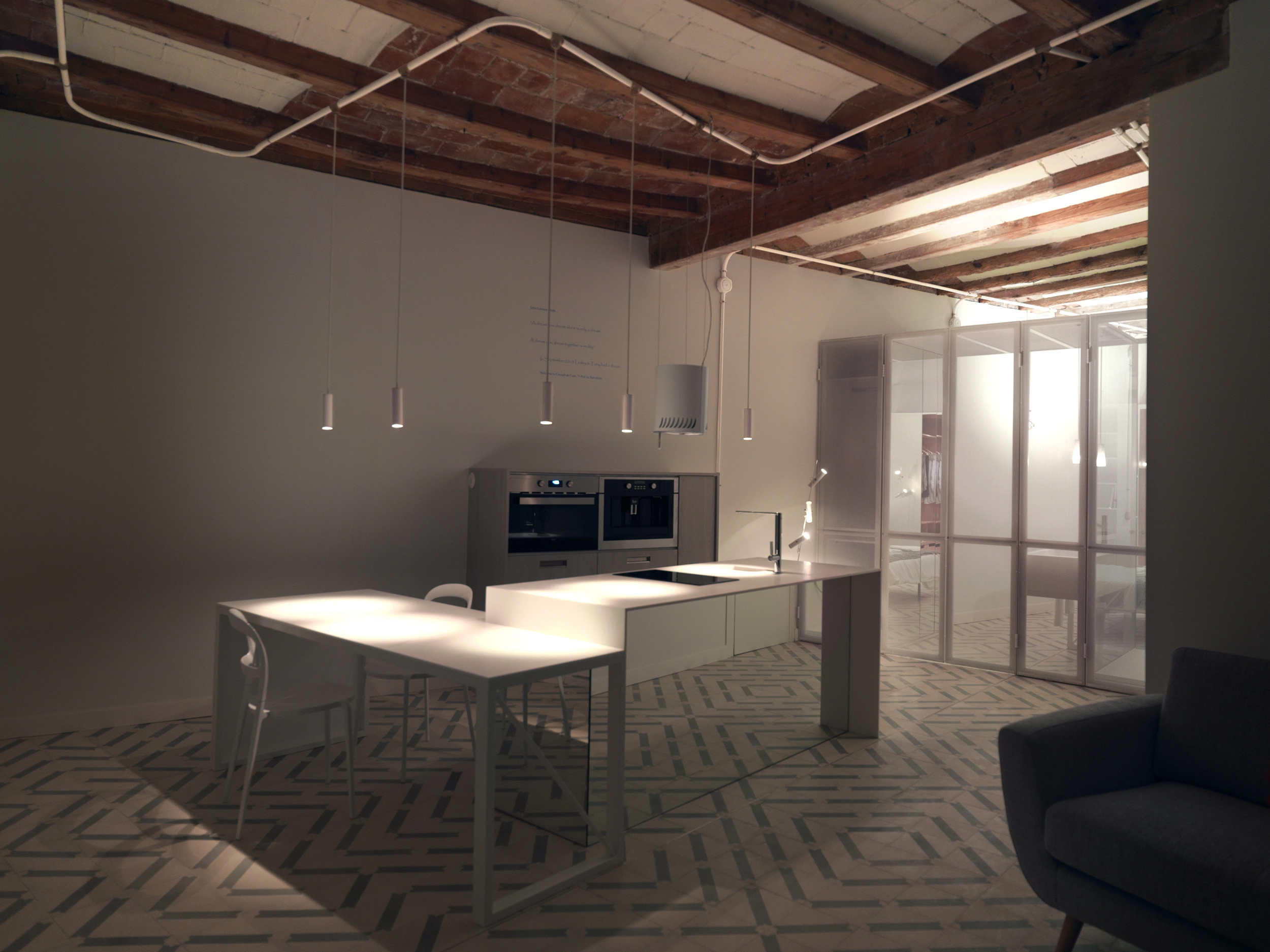 Minimal kitchen with pendant lighting and Catalan ceiling at night in The Lightslice apartment by Cometa Architects