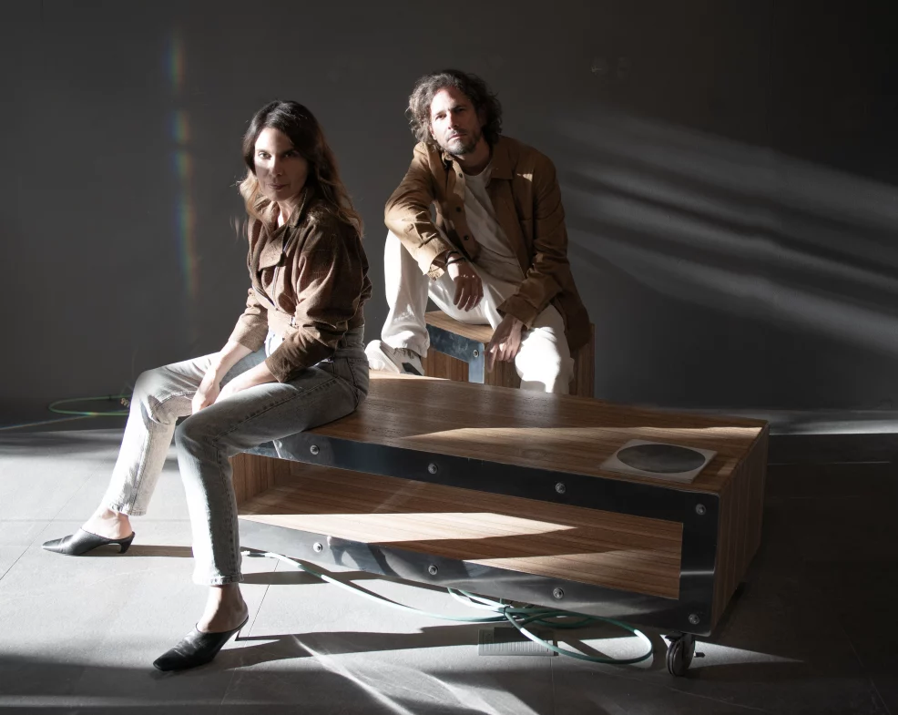 Studio portrait of Cometa Architects founders Víctor González Martí and Faidra Matziaraki in their Barcelona workspace.