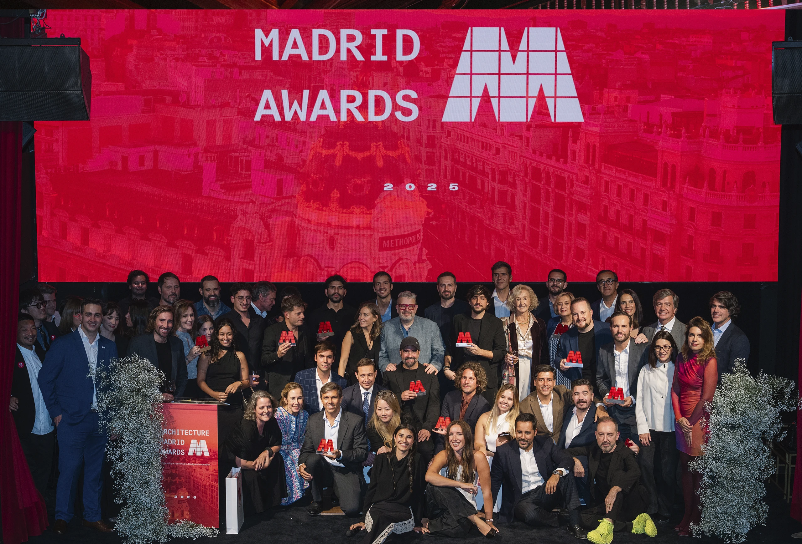 Group photograph of all award winners on stage at the Architecture Madrid Awards 2025.