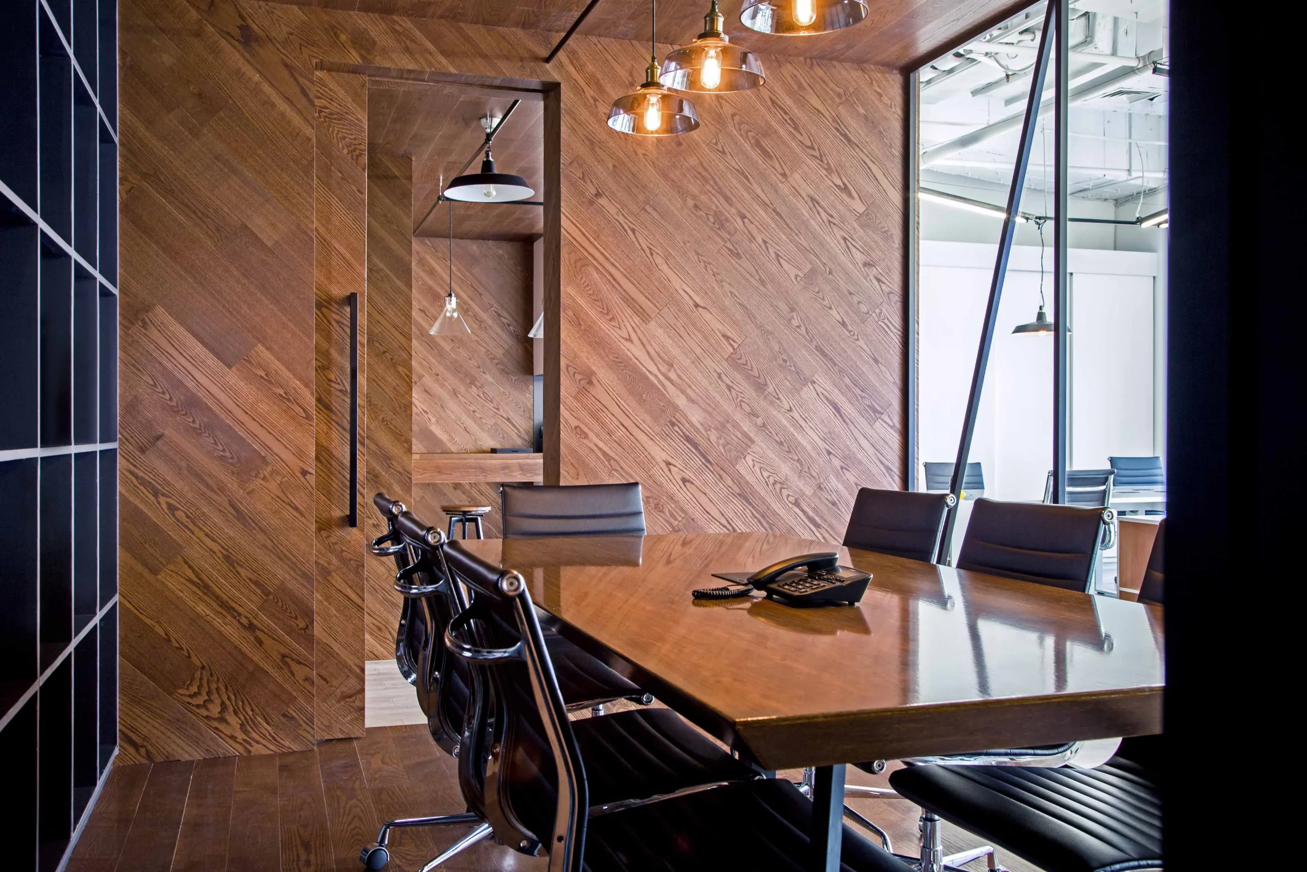 meeting room with wooden table and diagonal wood walls at bpo office shanghai by cometa architect