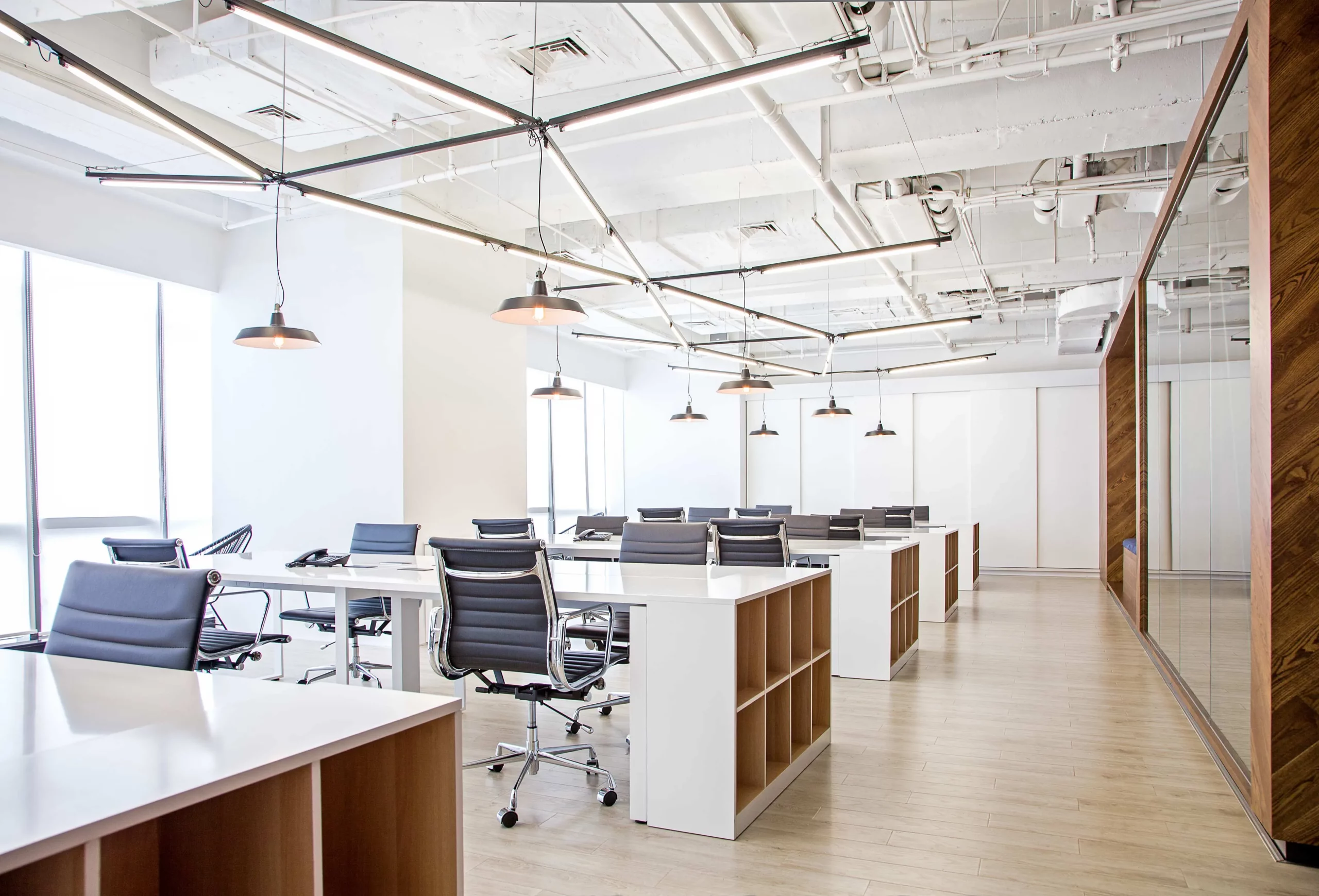 open workspace with custom lighting grid and exposed ceiling at bpo office shanghai by cometa architects