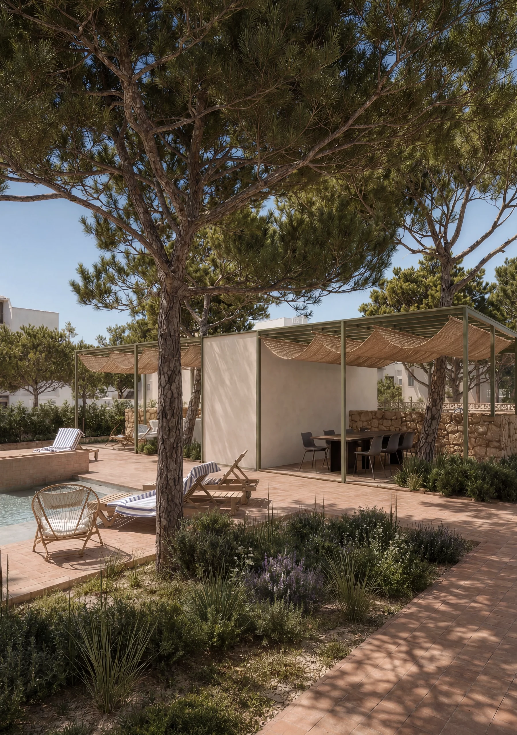 Exterior view of Sa Capçada in Mallorca showing a pool house under pine trees, terracotta paving, pergola shade, Mediterranean planting and a salt-water pool.
